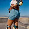 Rusty brown skort over blue inner shorts, side view with bow tie