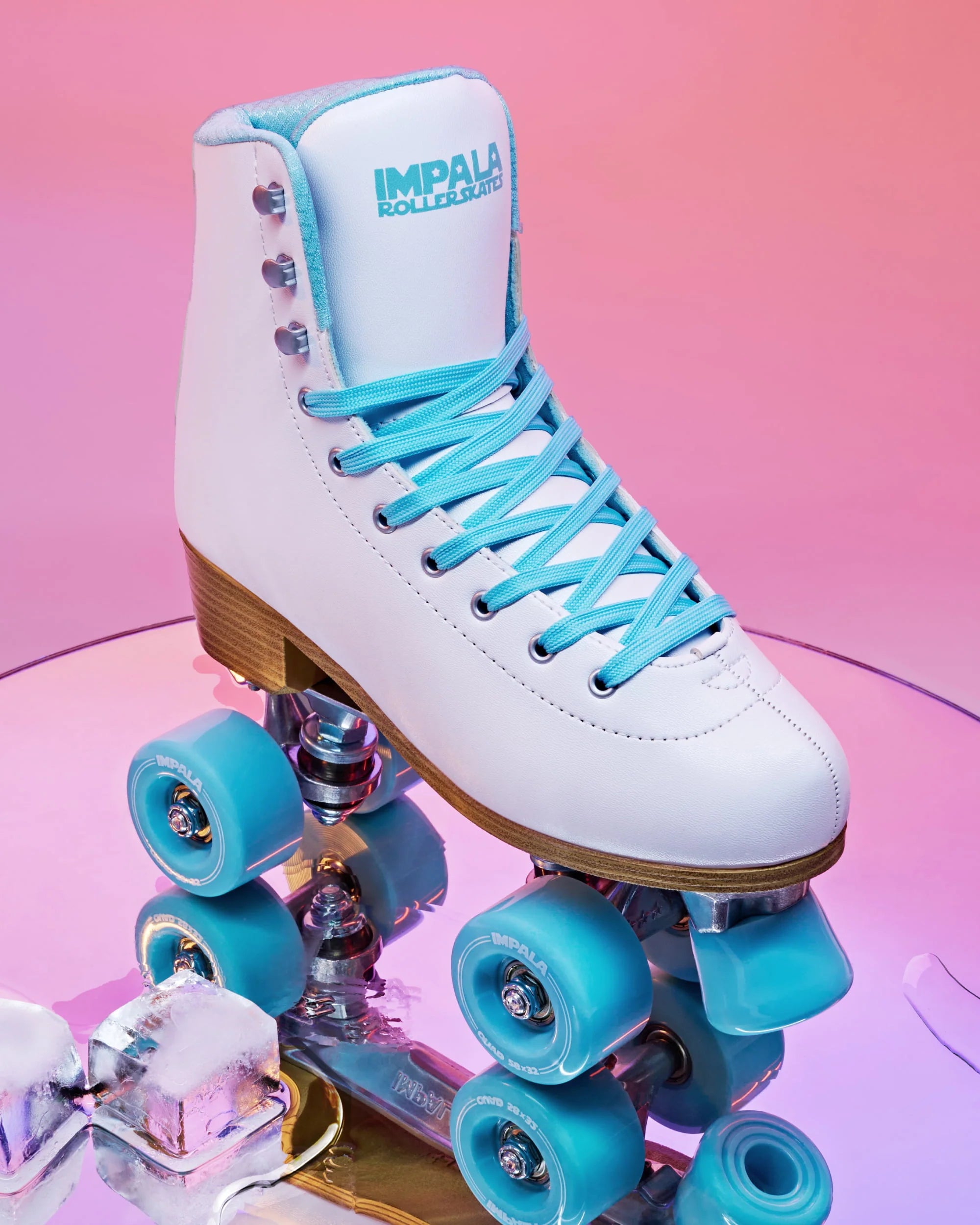 White quad skates with light blue laces, wood-toned sole, and blue wheels