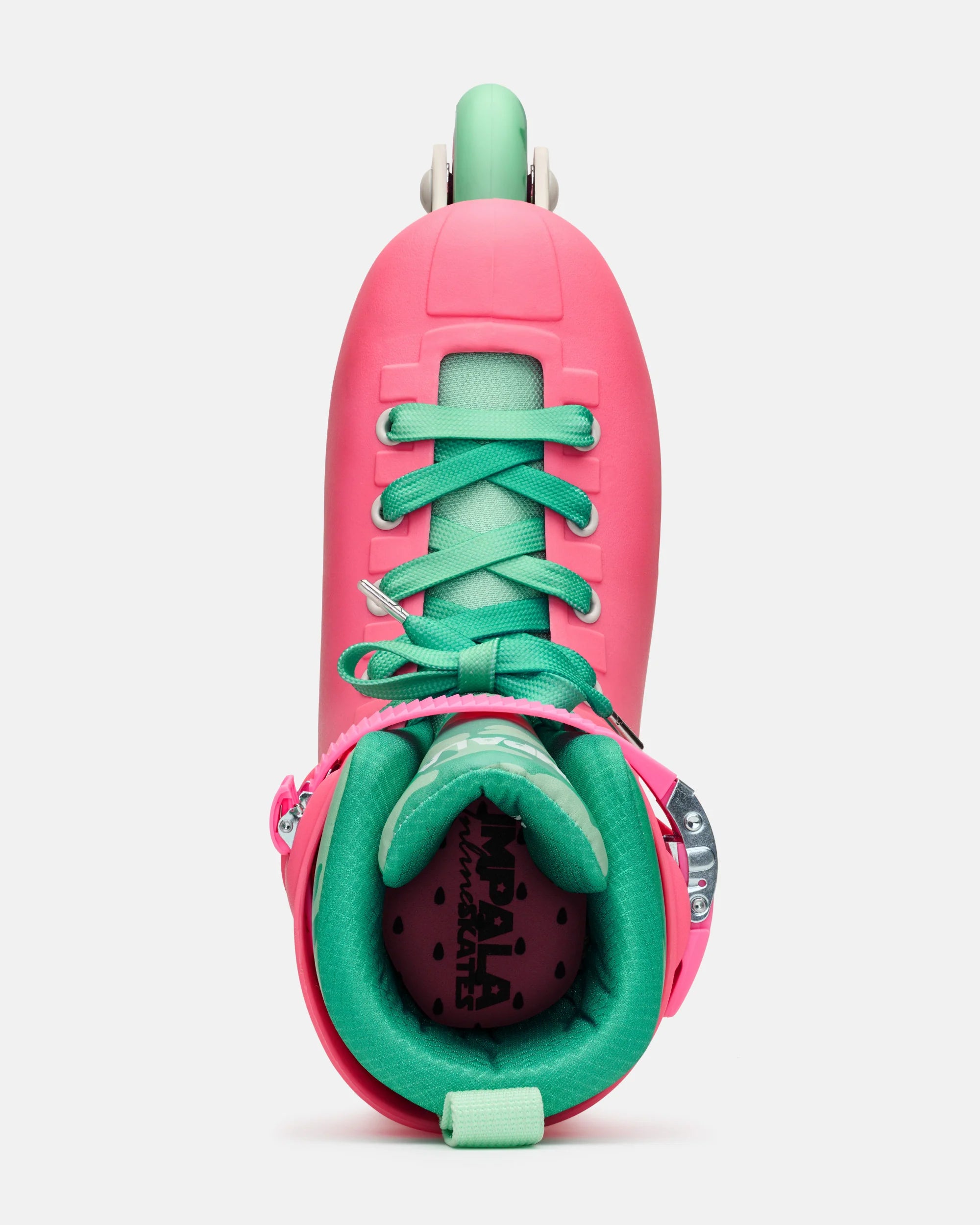 Top-down view of pink inline skates with green laces and open boot interior