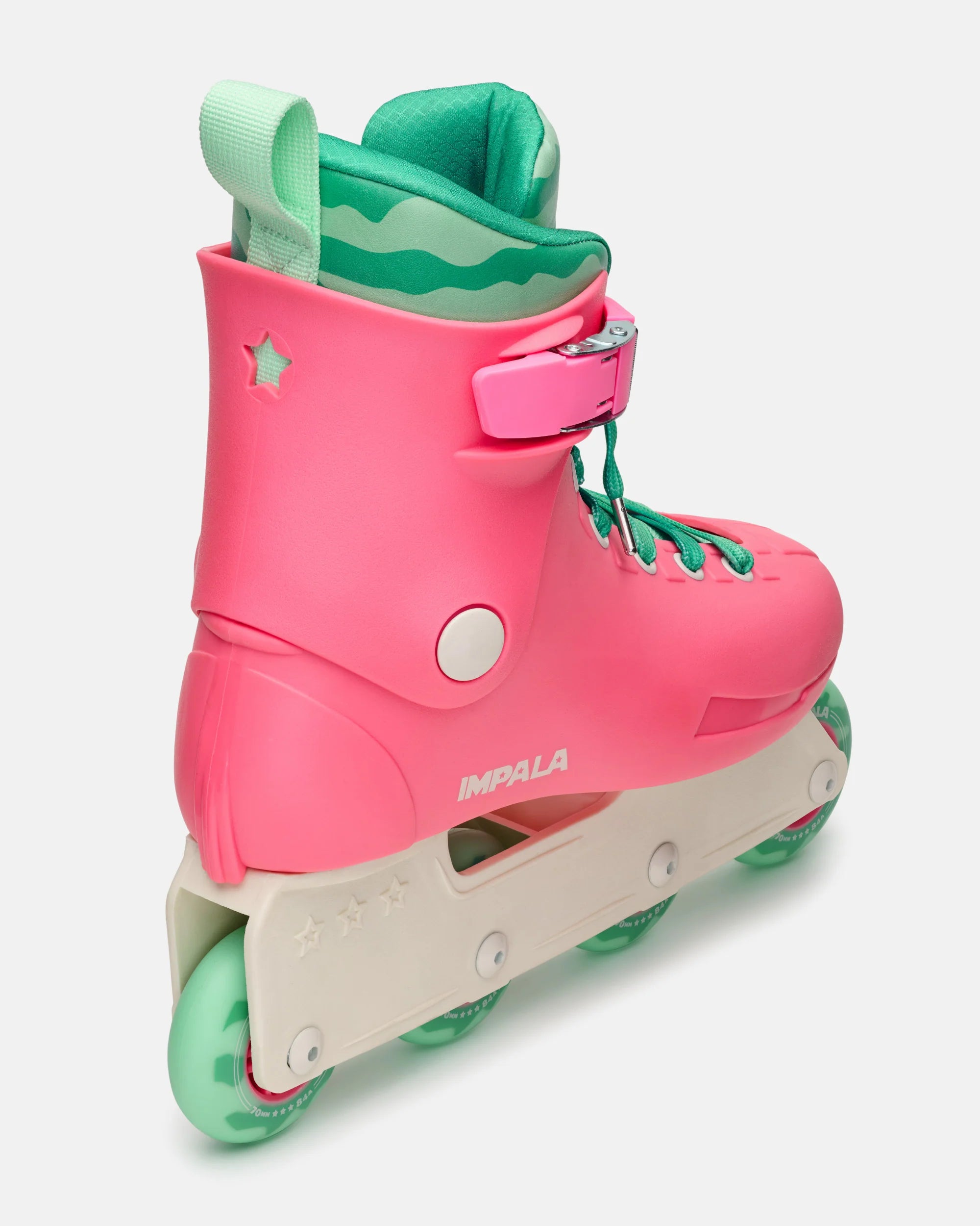 Diagonal side view of pink and green inline skates with adjustable buckle strap