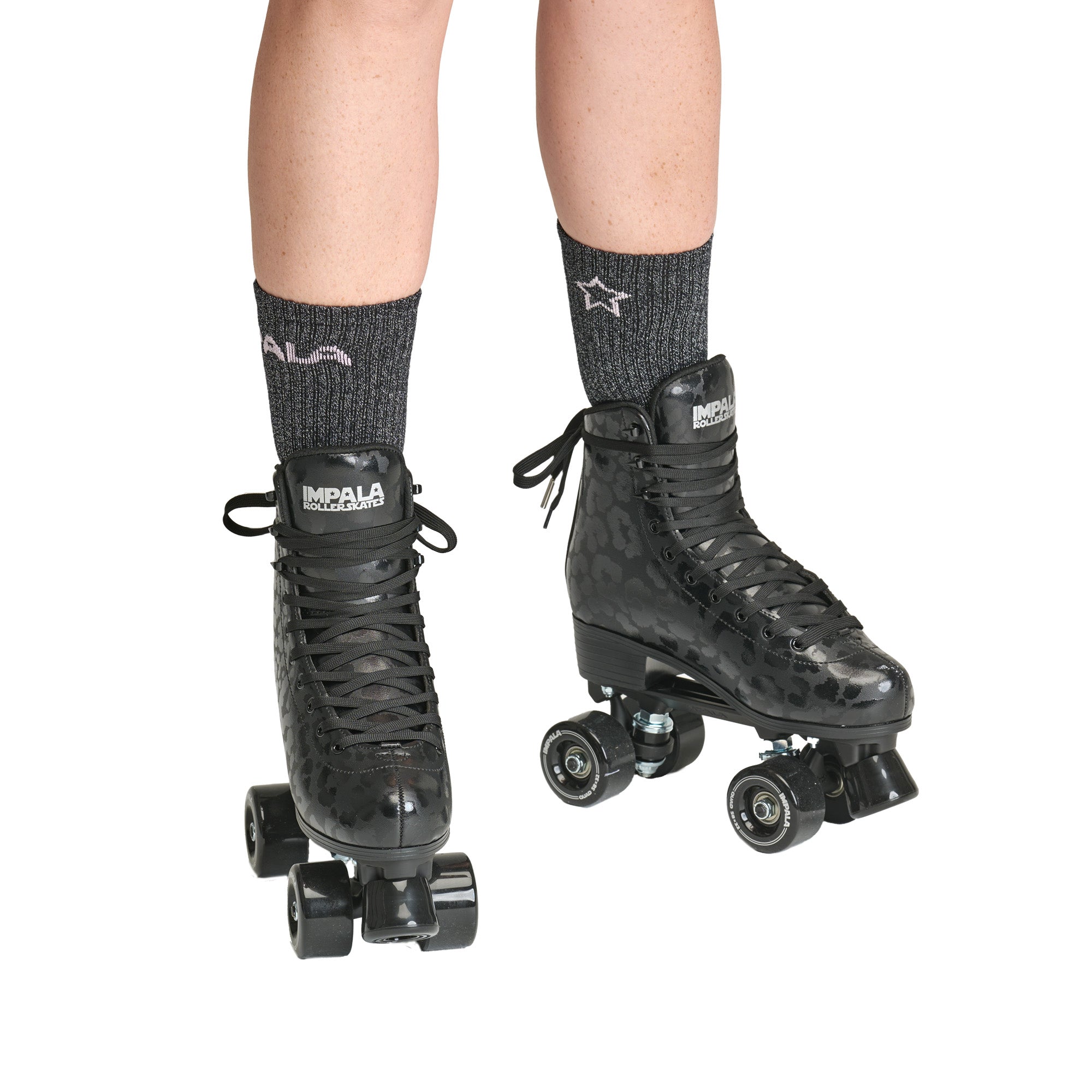 Impala quad roller skates on legs, black leopard high-top lace-up boots with quad wheels