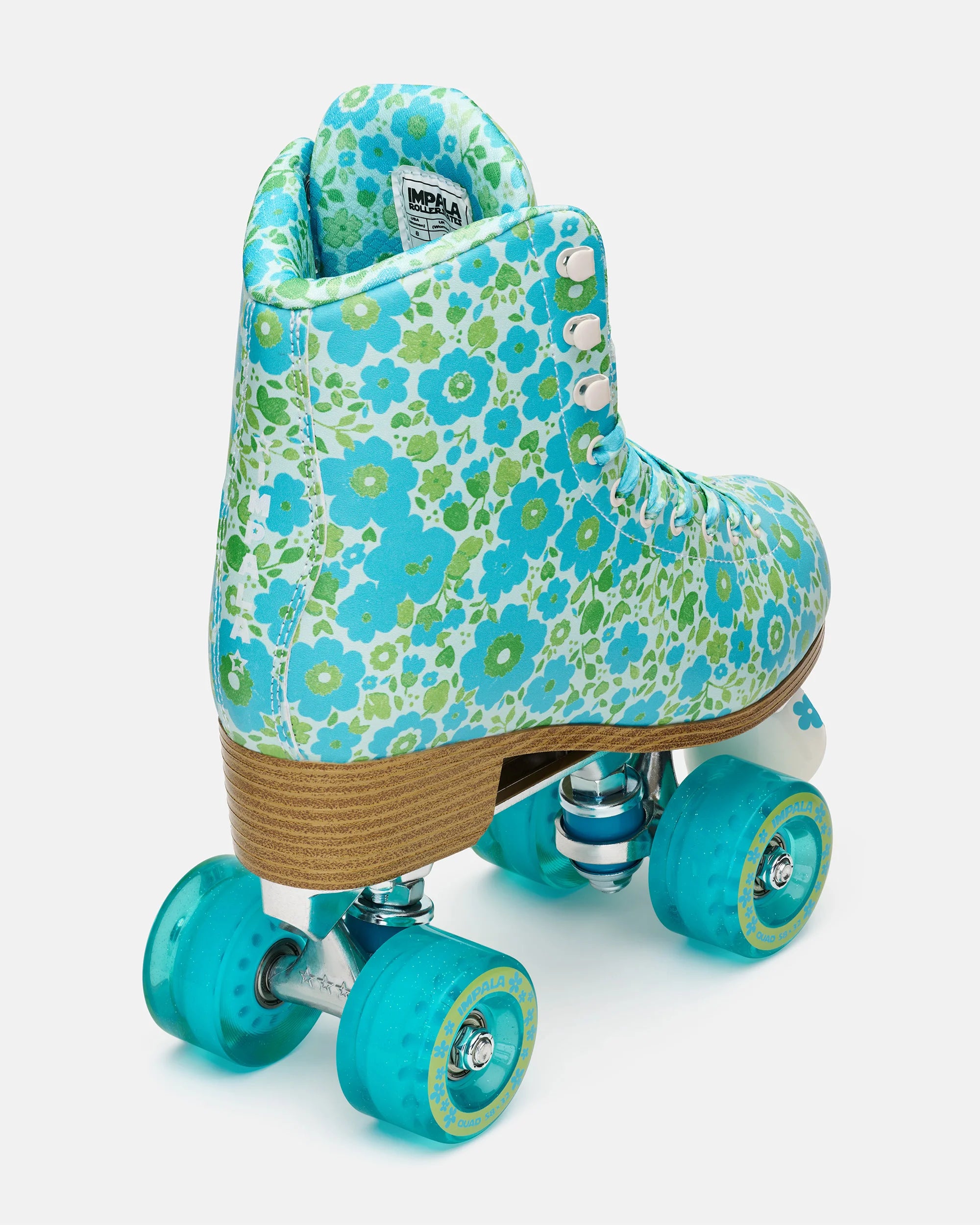 Teal floral high-top quad skates with turquoise wheels and tan wooden sole
