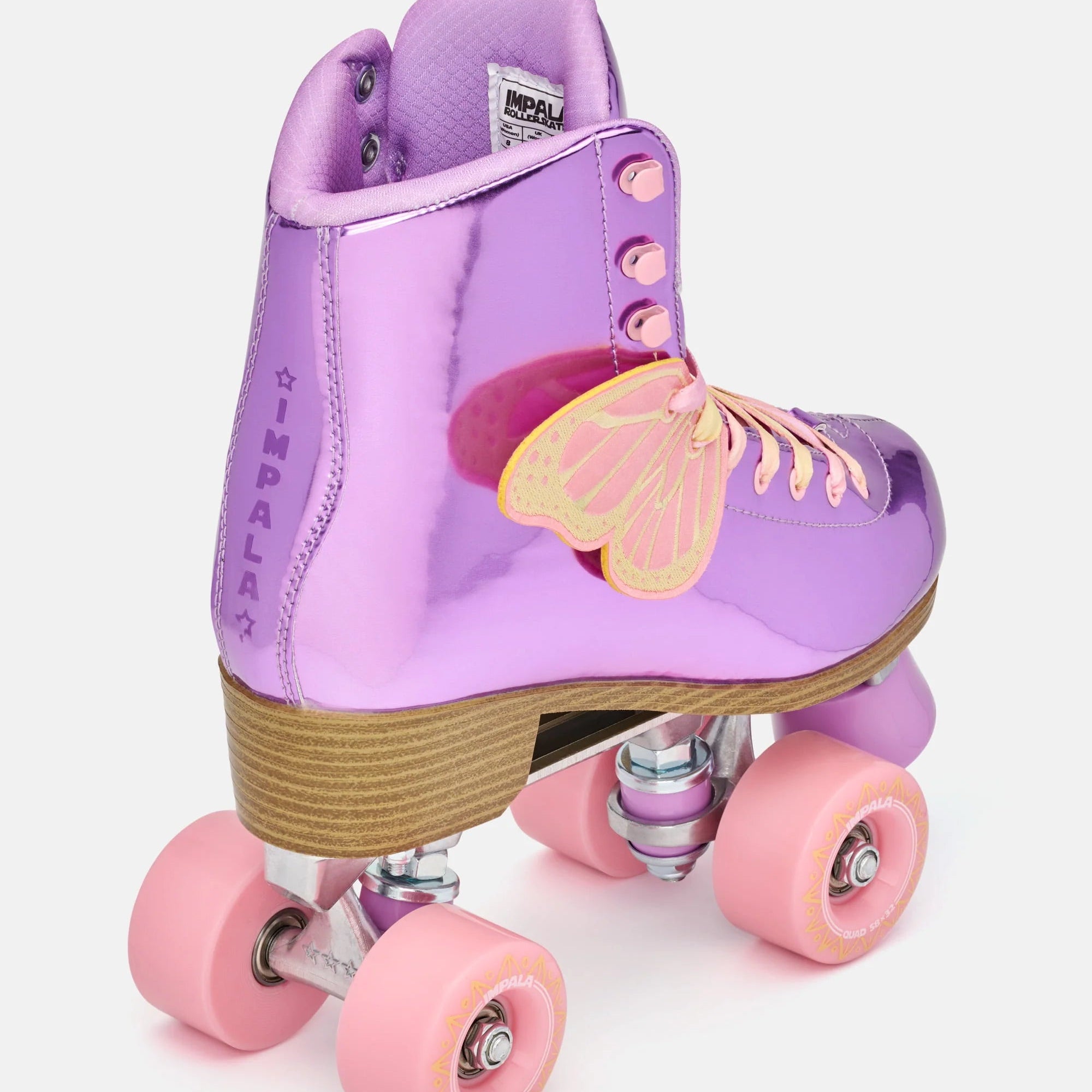 Lavender high-top quad skates with pink wheels, textured tan sole, butterfly ornament