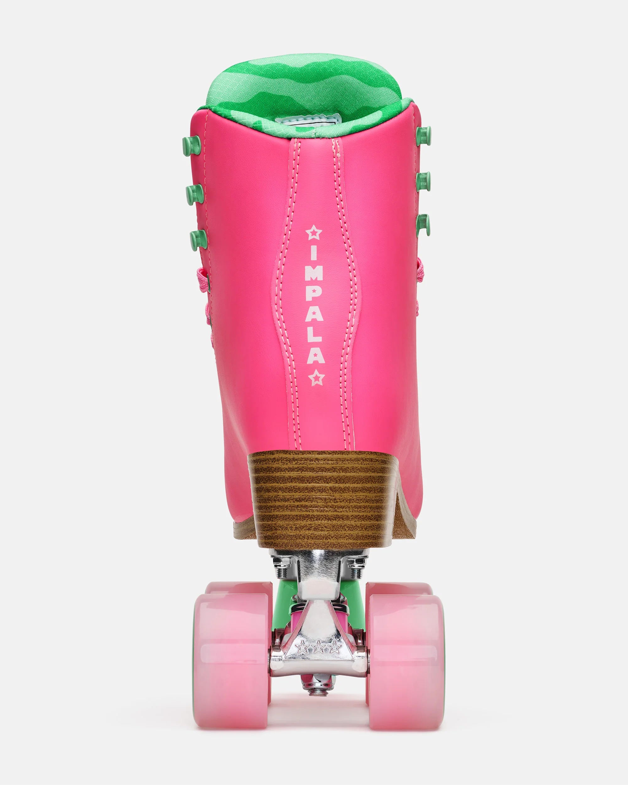 Pink quad skates with green padded lining; back shows IMPALA logo stitching