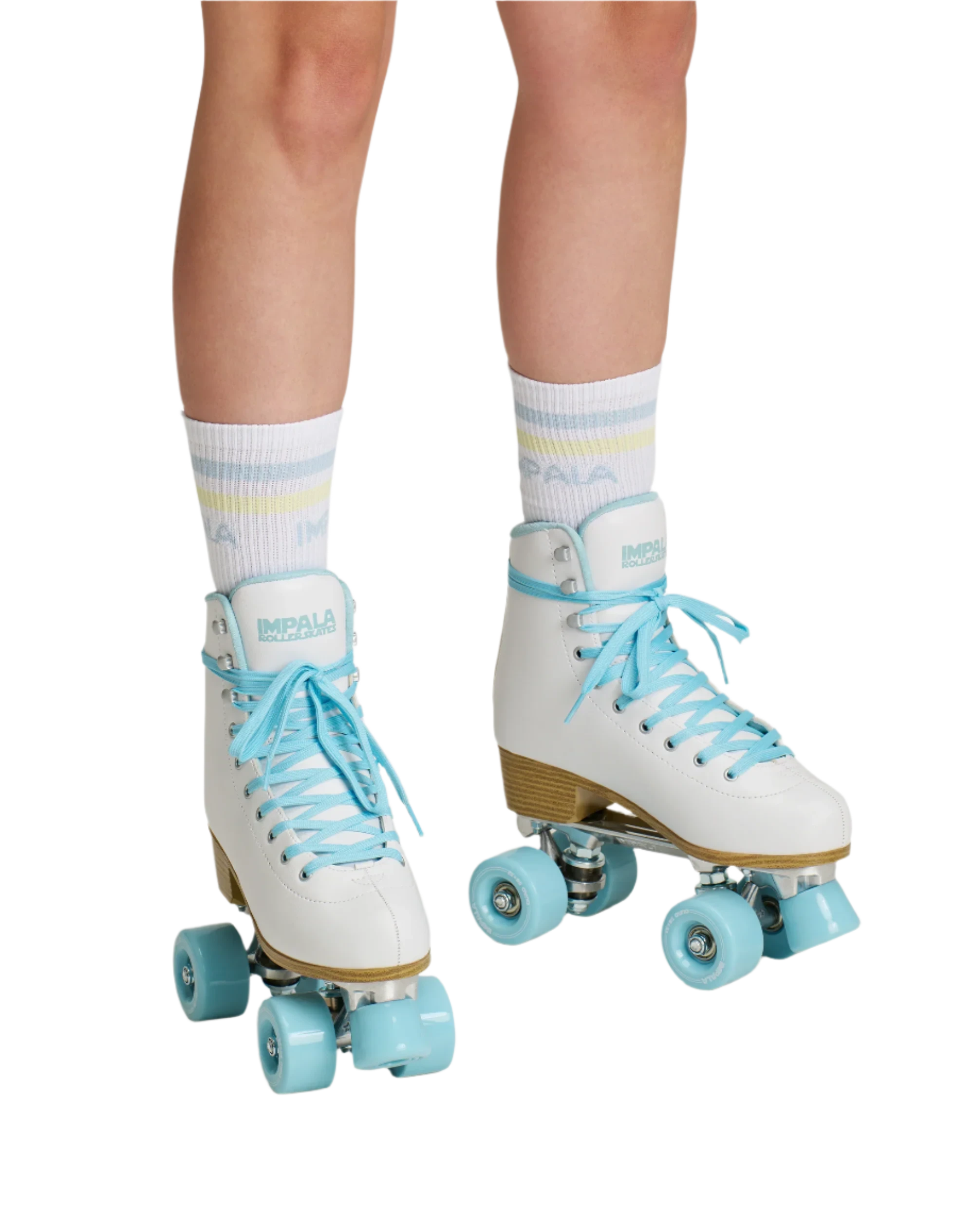 White quad skates on rollers, light blue wheels, worn with white striped socks
