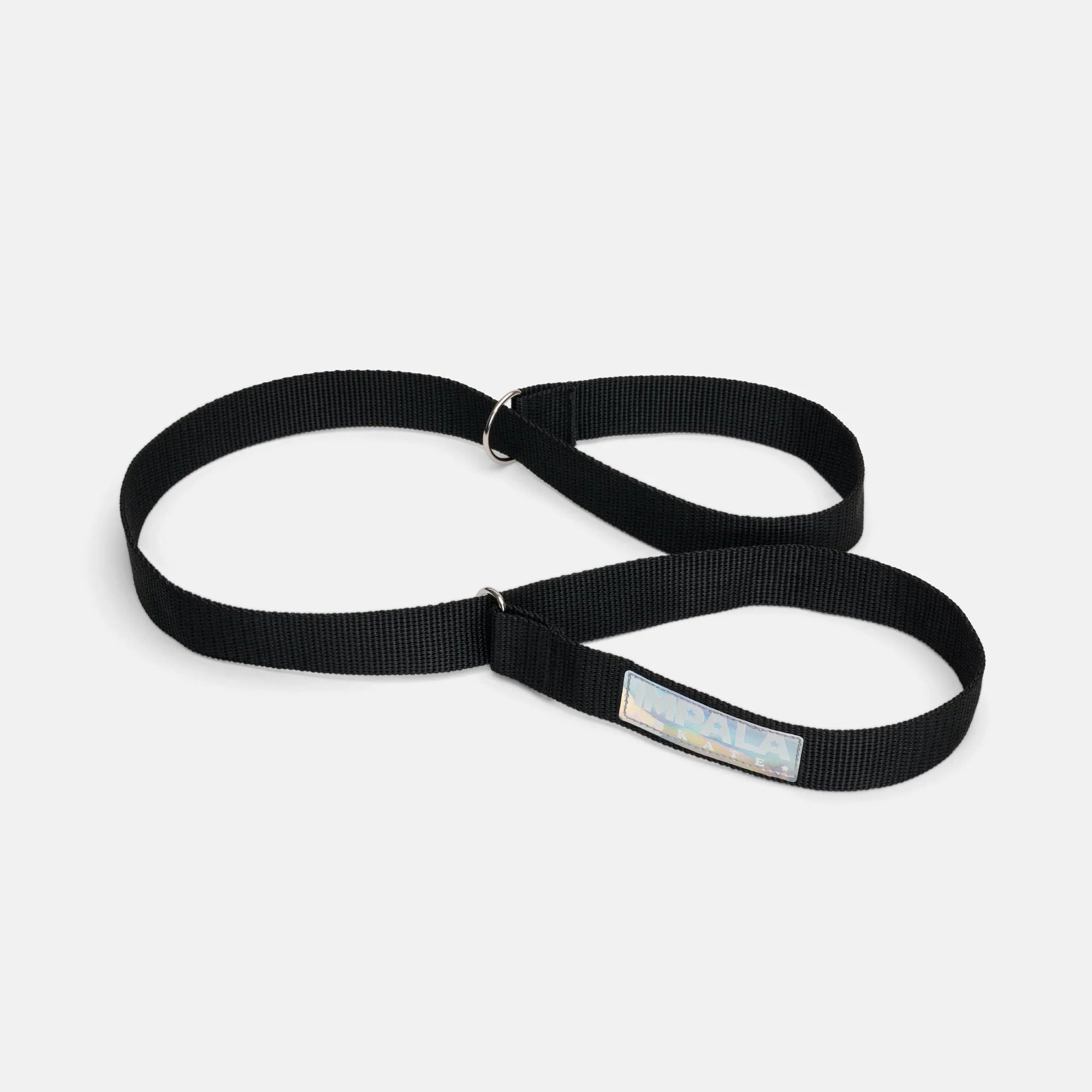 Black skate strap with adjustable metal rings and printed Impala label
