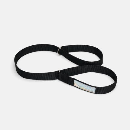 Black skate strap with adjustable metal rings and printed Impala label