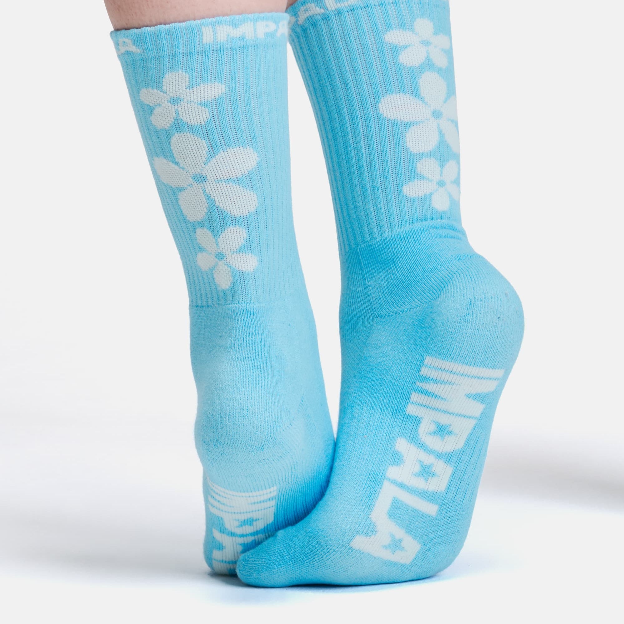 Crew socks, turquoise blue with vertical stripe texture and clover print