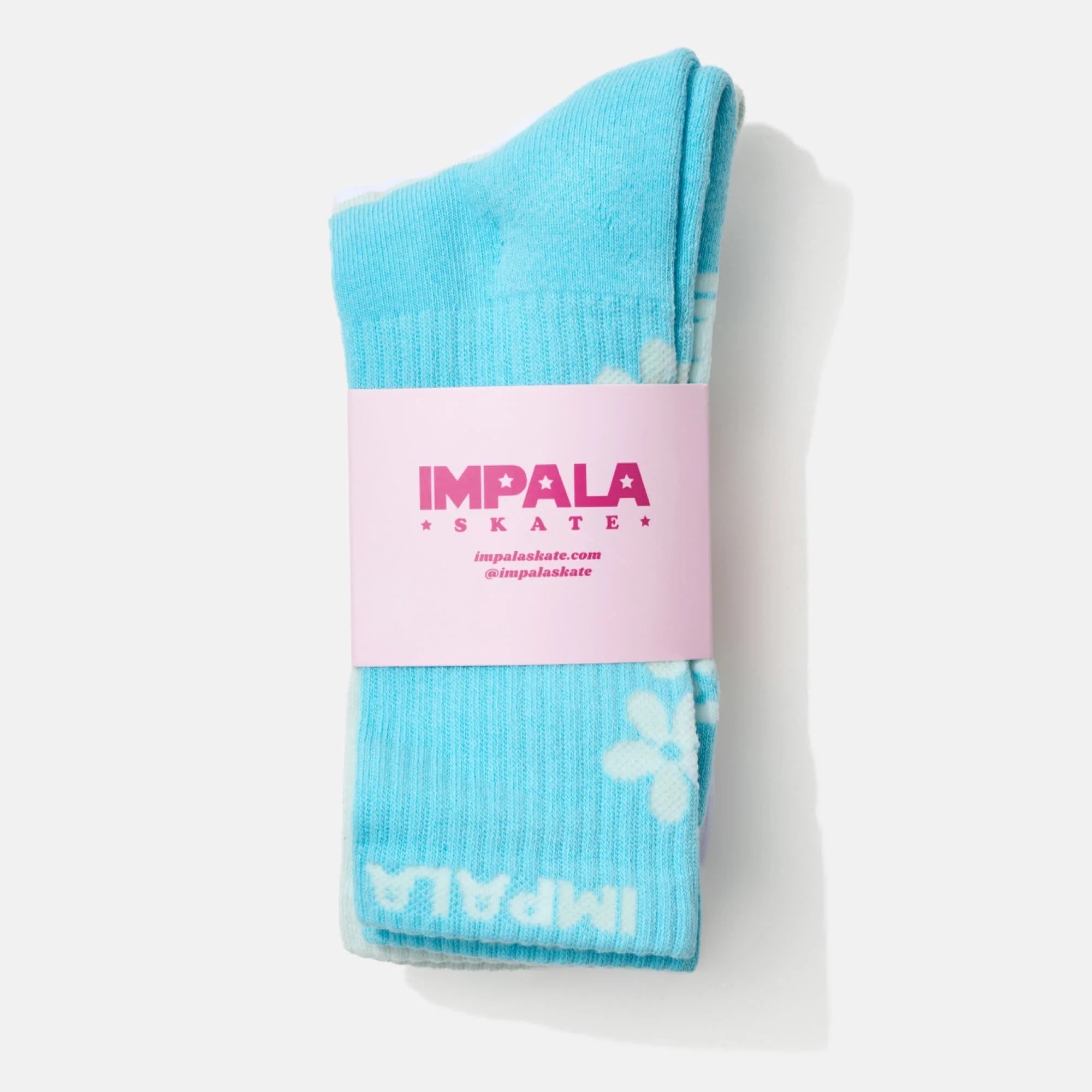 Folded crew sock with Impala Skate tag, turquoise blue with clover print