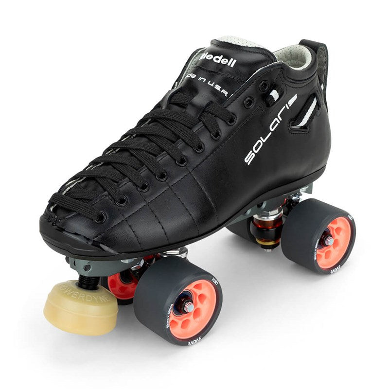 Black Riedell derby roller skates with orange wheels and yellow toe stop pads