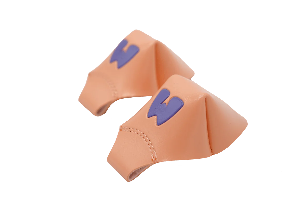 Peach toe caps with navy character logo and curved toe shape