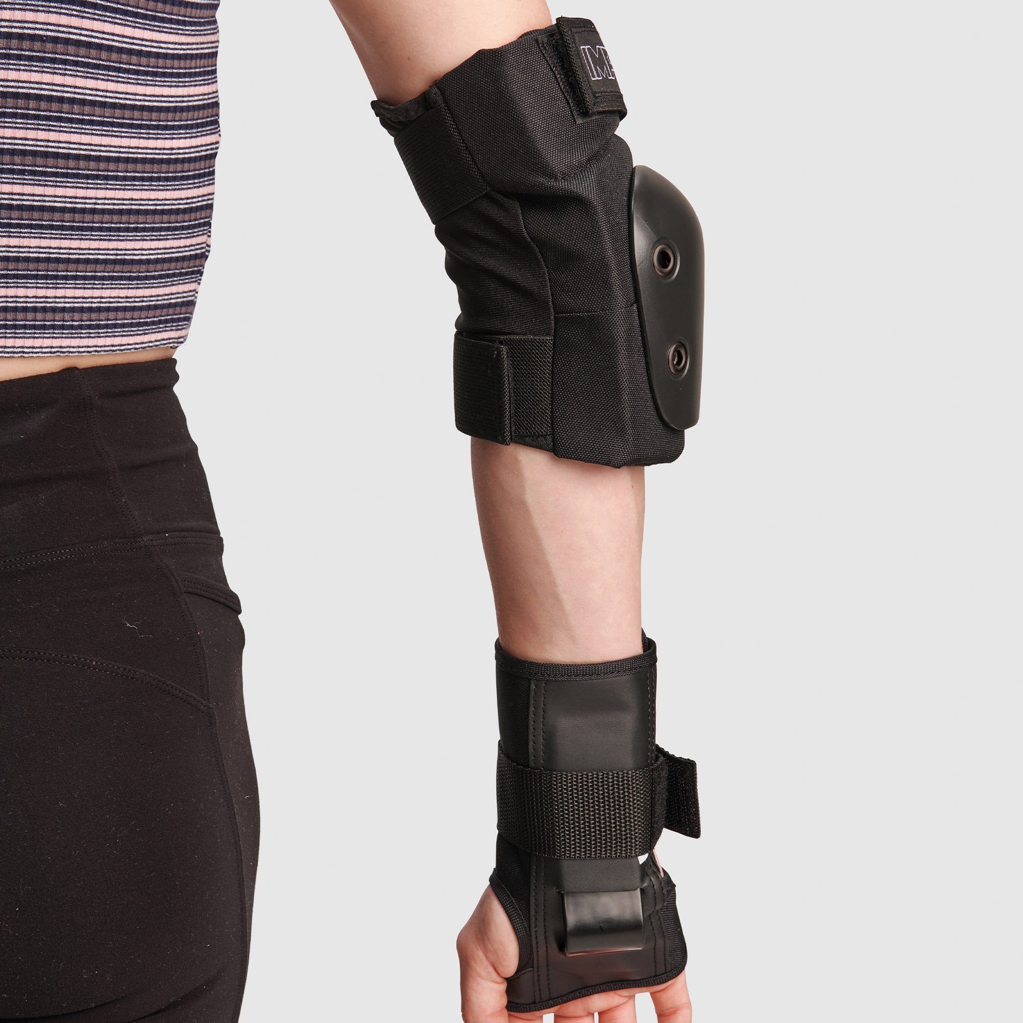 Black knee pad with hard shell and adjustable strap on leg
