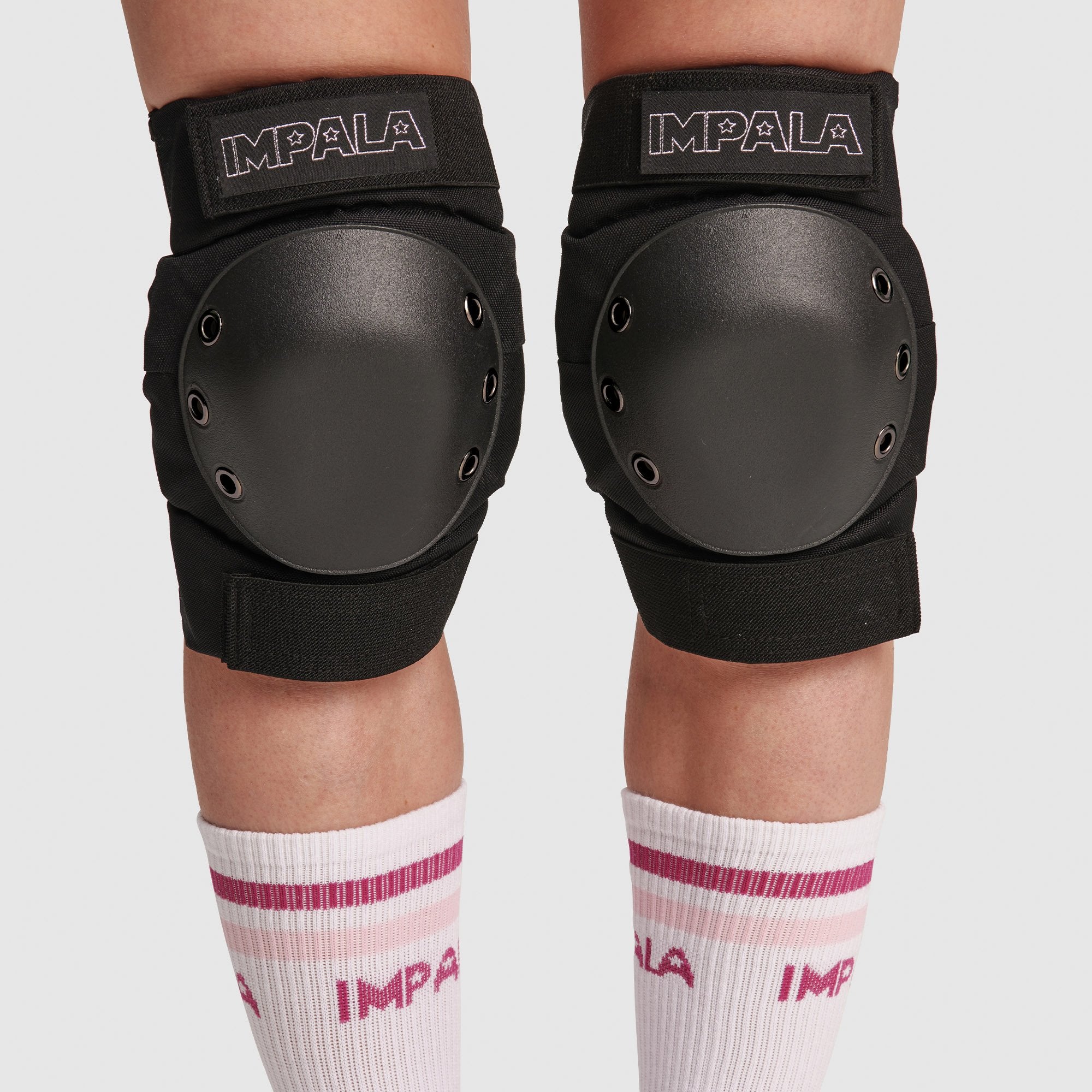 Pair of black knee pads with round hard shells and IMPALA logos
