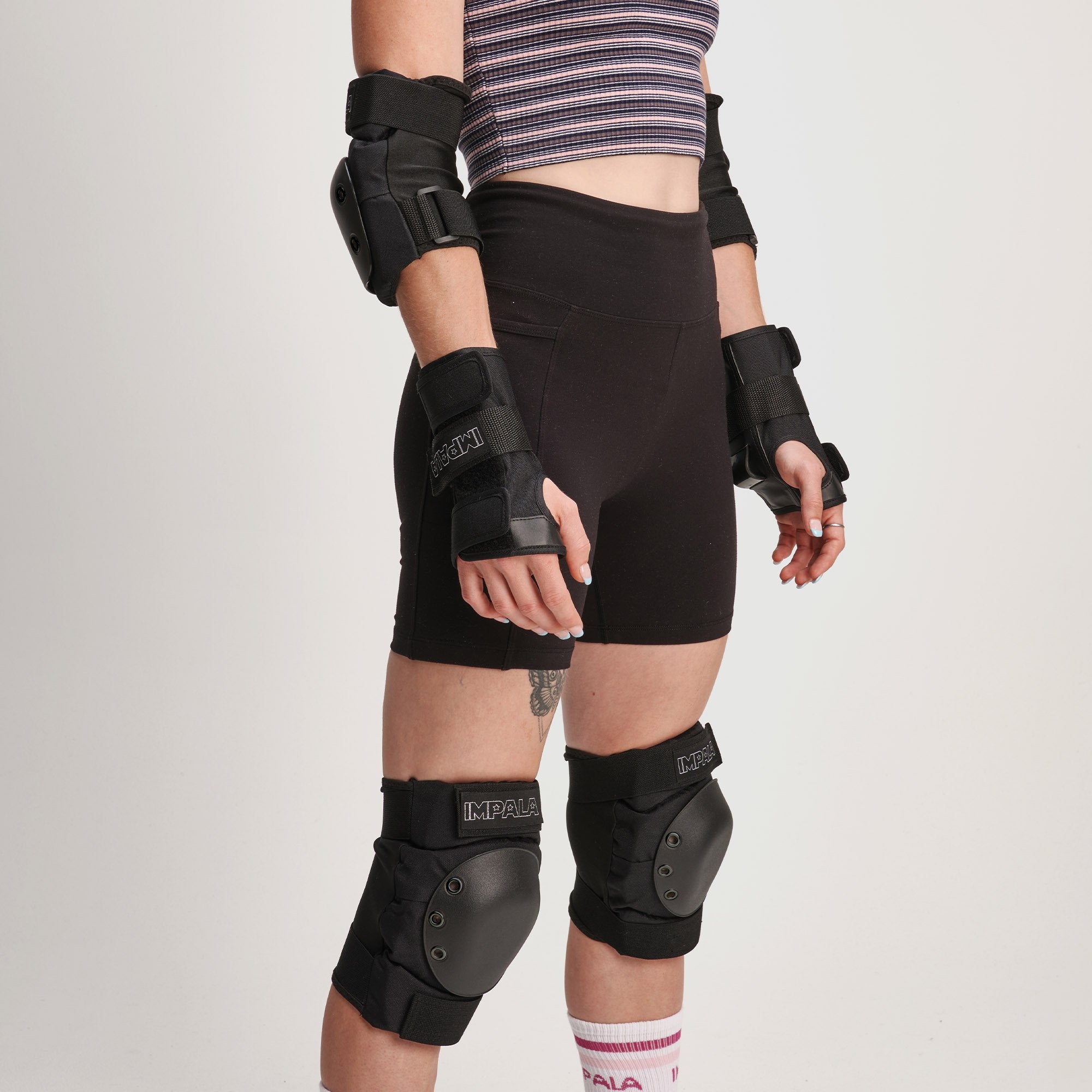 Black protective set worn: knee pads and forearm guards with hard shells