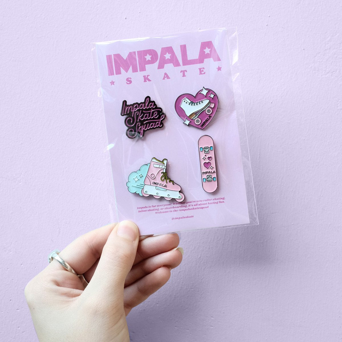 Skate-themed enamel pin set on card with multiple graphic pins in pink and blue