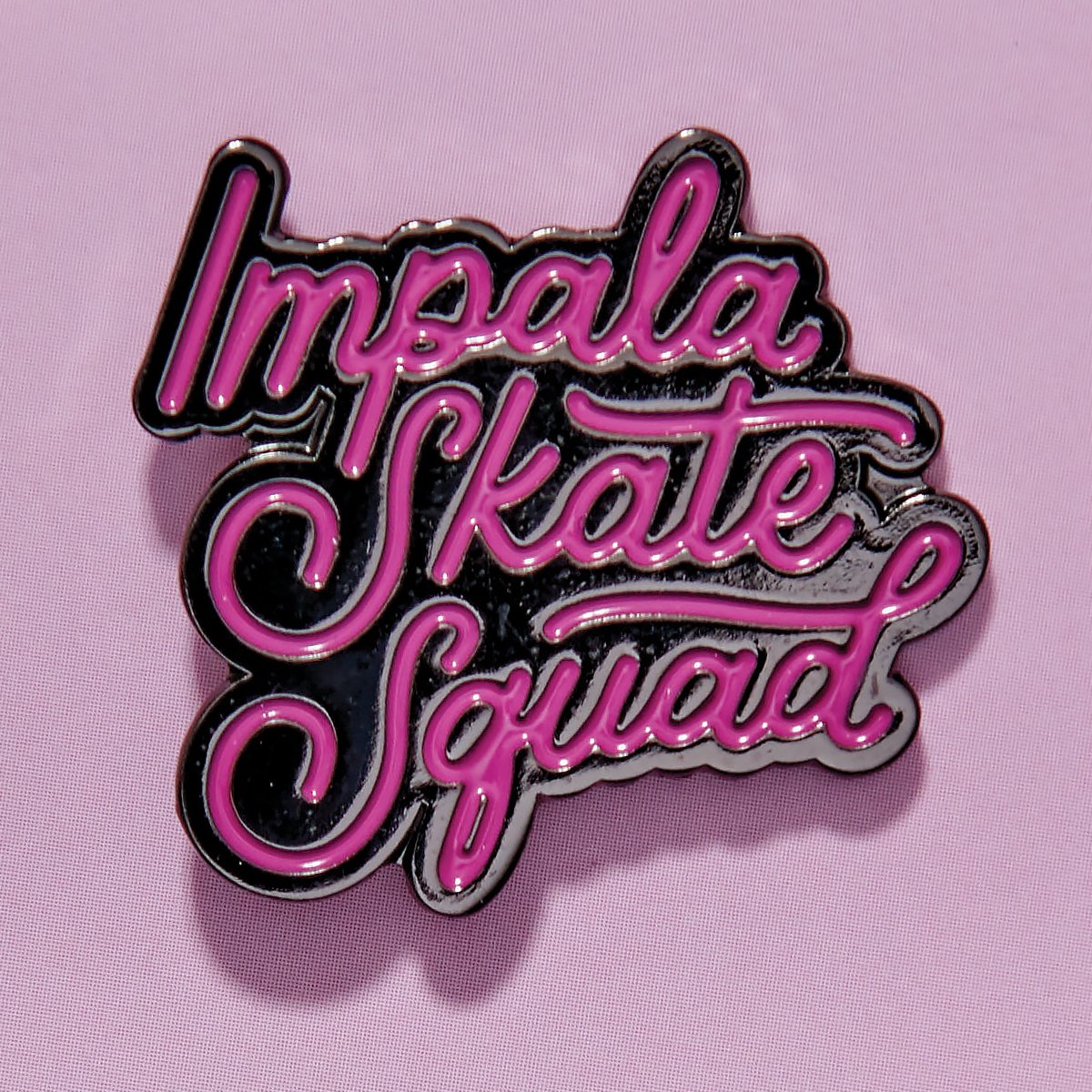 Impala Skate Squad logo enamel pin with black, pink, and silver lettering