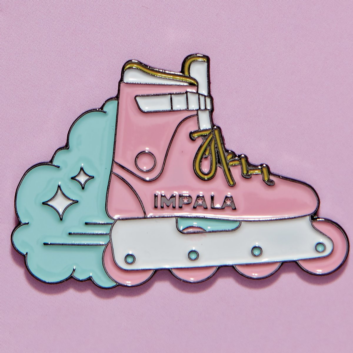Skate shoe enamel pin with teal cloud accents and pink base, small 'IMPALA' text
