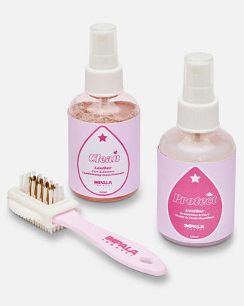 Impala suede care kit with leather cleaner, protectant bottles, and white brush