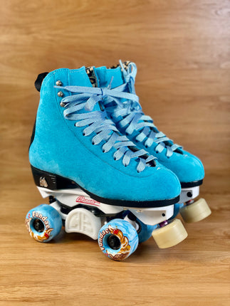 Blue suede high-top roller skates with light-blue laces and colorful wheel decals