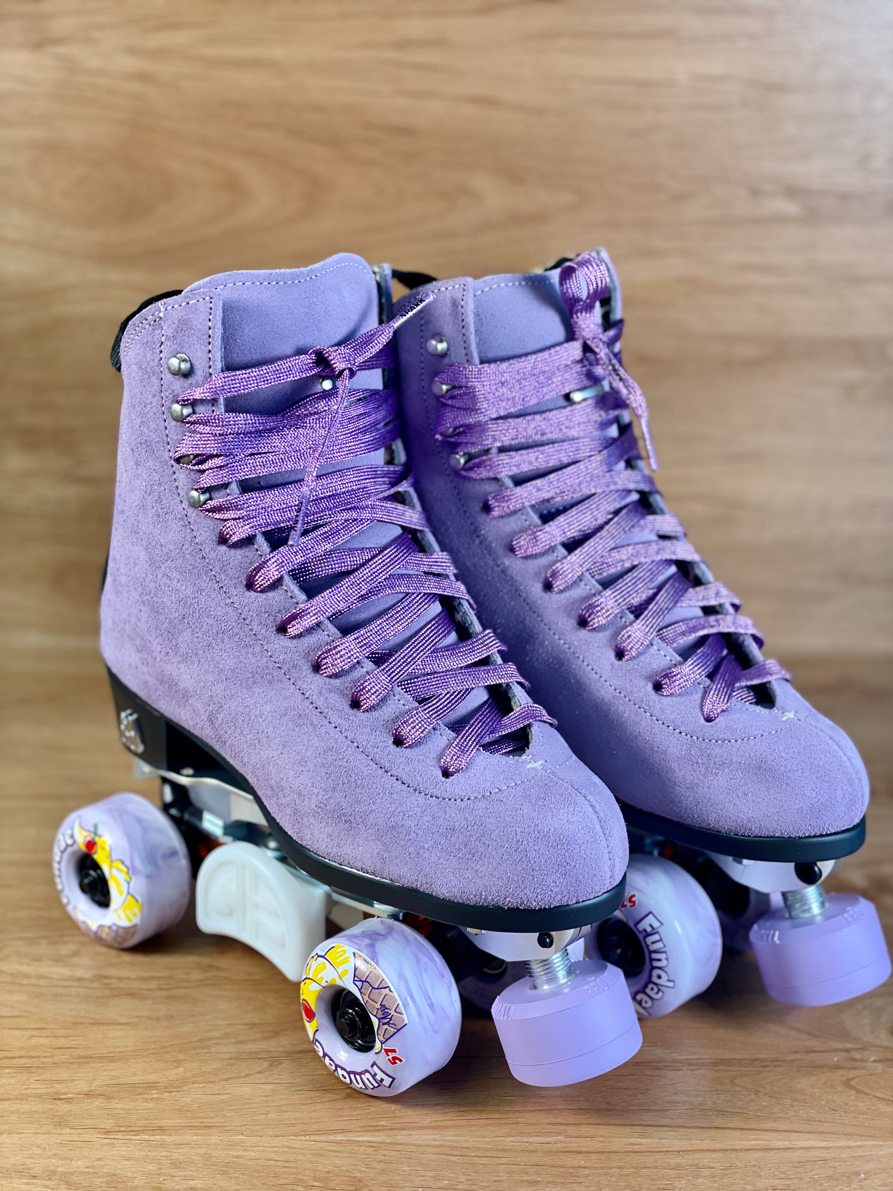 Lilac suede high-top roller skates with purple laces and star wheels